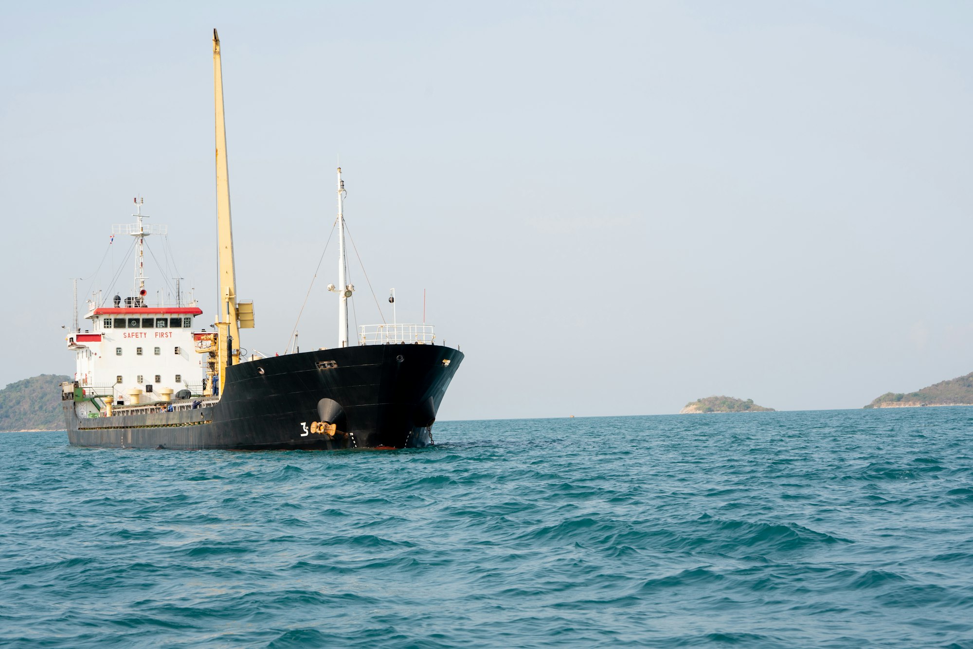 cargo ship in the ocean for export import goods from cargo yard port to customs ocean